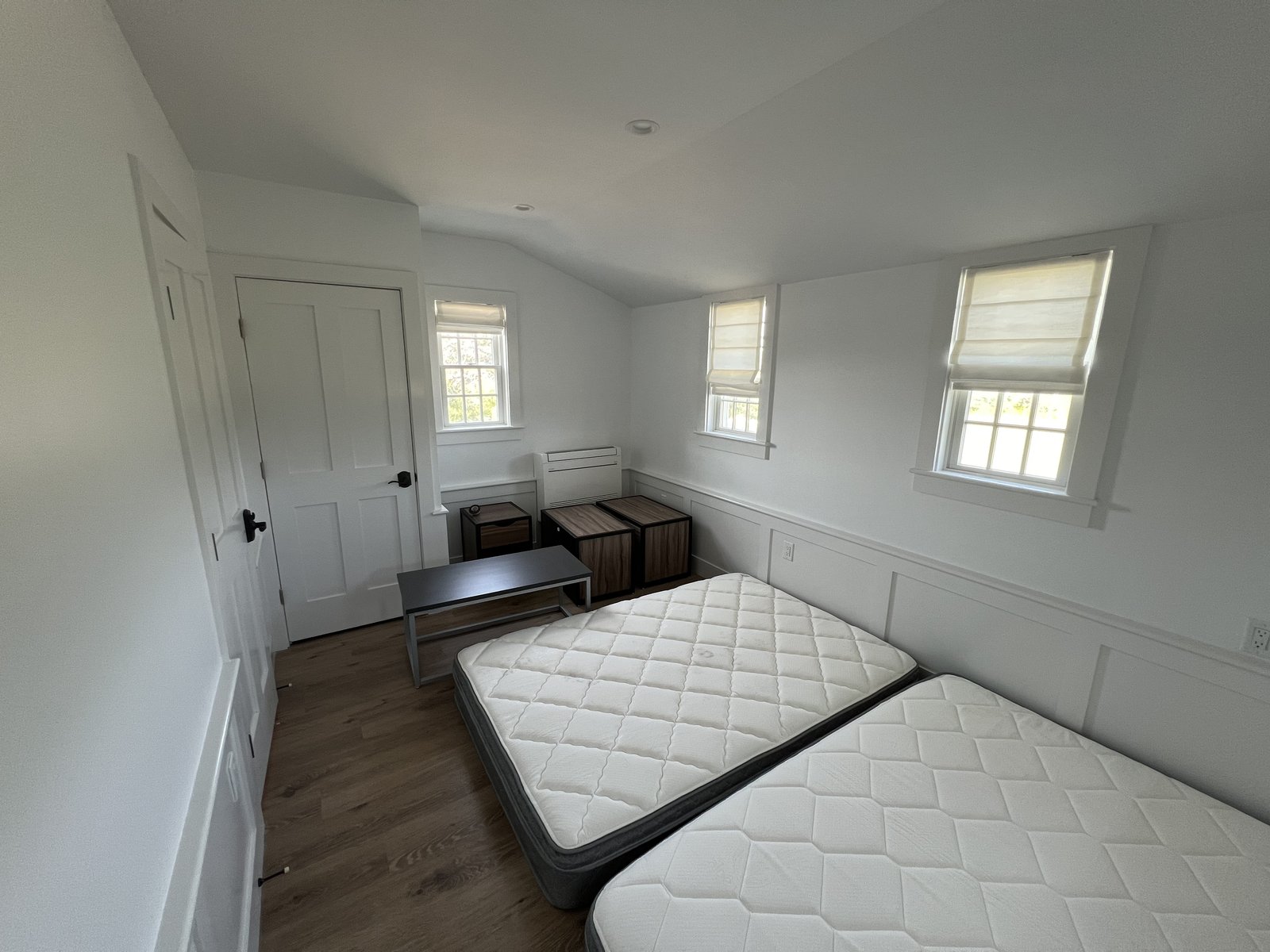 Finished bedroom with dormer windows and hardwood floors