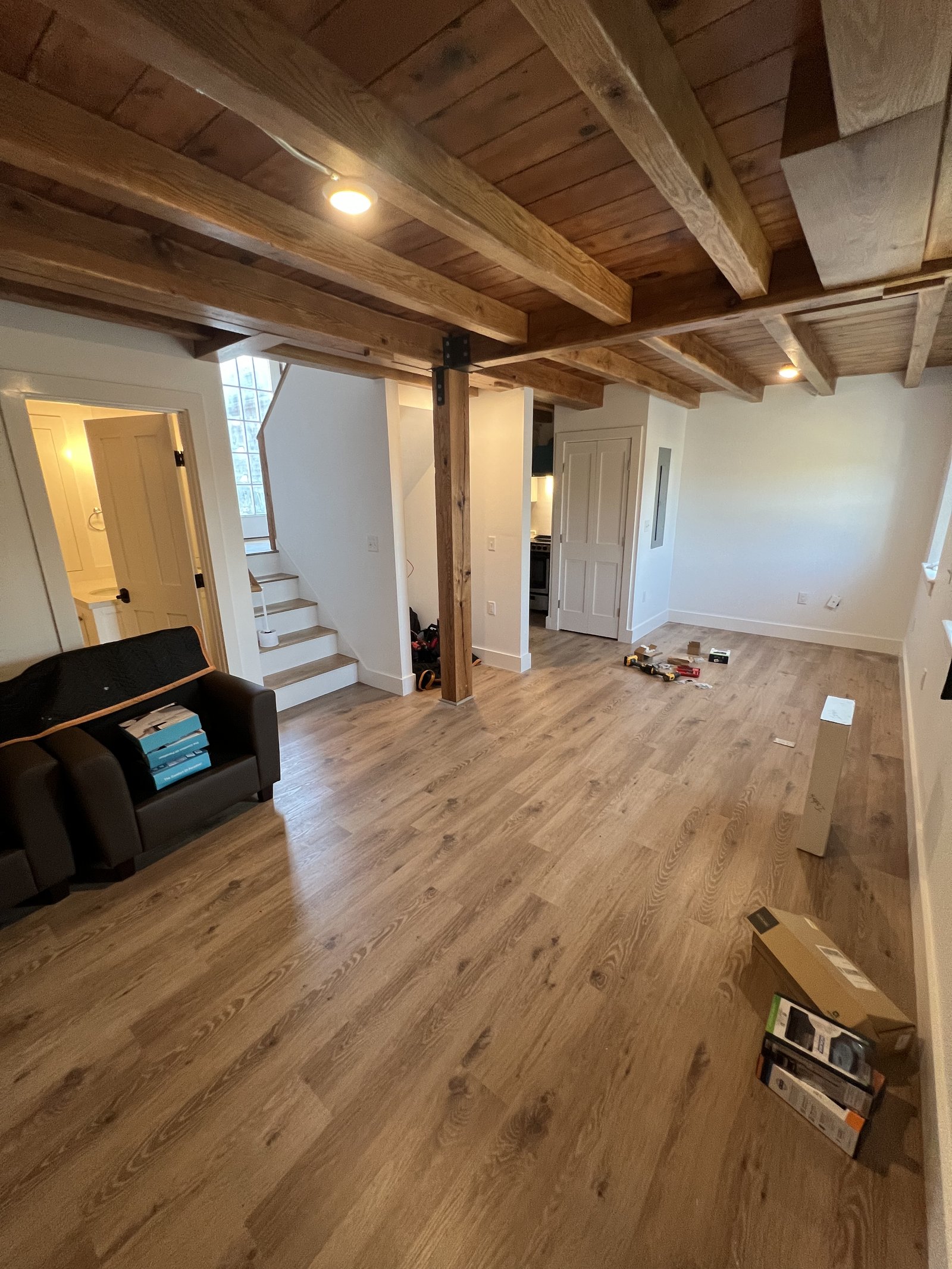 Finished living space with exposed beams and custom woodwork